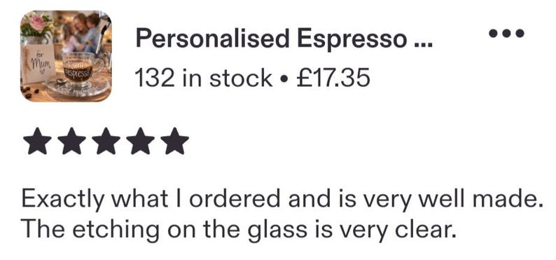 May include: A clear glass espresso cup featuring the text "Sam's espresso" etched on the front surface. The cup is positioned on a matching glass saucer, with a small wooden sign nearby that reads "for Mum" with a heart symbol, and coffee beans.