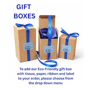 May include: Three brown cardboard gift boxes of varying heights, each wrapped with a bright blue satin ribbon. The center box is open, revealing blue tissue paper inside. Each box features a light blue rectangular label with the text CC Calligraphy.
