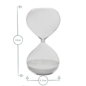 May include: A clear glass hourglass with white sand inside. The hourglass is 18 cm tall and 8.5 cm wide. The design is simple and elegant, suitable for home decor or as a functional timer.