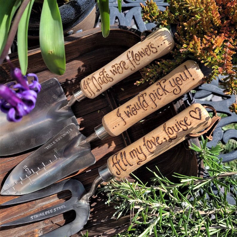 set of three garden tools with wooden handles and steel tops, a fork, a trowel a planter, hand engraved in a calligraphy font with the words If Dads were flowers...I would pick you! All my love, Louise ❤ or you can choose your own messages