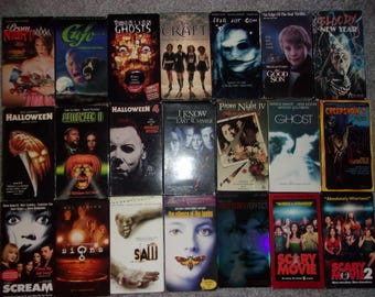 May include: A collection of 20 VHS tapes featuring horror movie titles such as "Scream", "Halloween", "The Craft", "Ghost", "I Know What You Did Last Summer", "Prom Night", "Signs", "Saw", "The Silence of the Lambs", "Scary Movie", and "Bloody New Year".