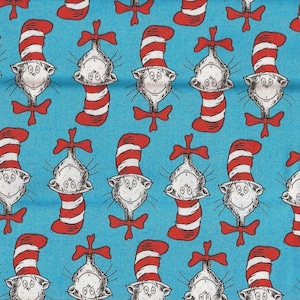 May include: Fabric with a repeating pattern of the Cat in the Hat from Dr. Seuss. The Cat in the Hat is depicted with a white face, whiskers, and a red bow tie. The cat is wearing a red and white striped hat. The background is a light blue.
