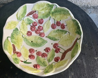 Magnificent salad bowl, enameled ceramic barbotine drainer, cherry and foliage pattern, vintage