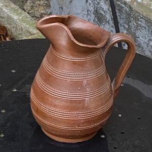 Pitcher, decanter, jug in old, vintage and designer stoneware, decorated with borders that gives it relief, artisanal, handmade