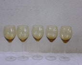 Set of glasses service consisting of 5 wine glasses, in yellow glass, chiselled with bunches of grapes and transparent base, vintage