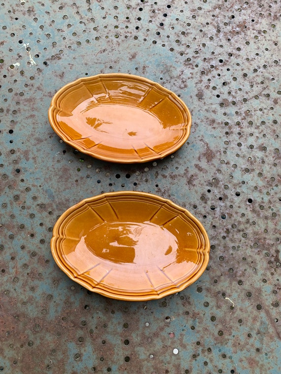 Two small serving dishes in enamelled ceramic, caramel color, made in France, signature two intertwined Cs, vintage