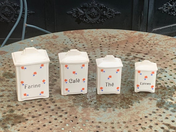 Series of 4 art deco spice jars, small flower patterns, blue, orange and yellow, in earthenware, made in Czechoslovakia.