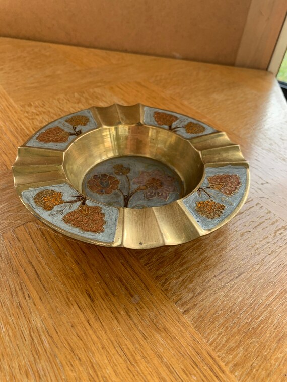 Brass ashtray with a vintage enameled floral pattern