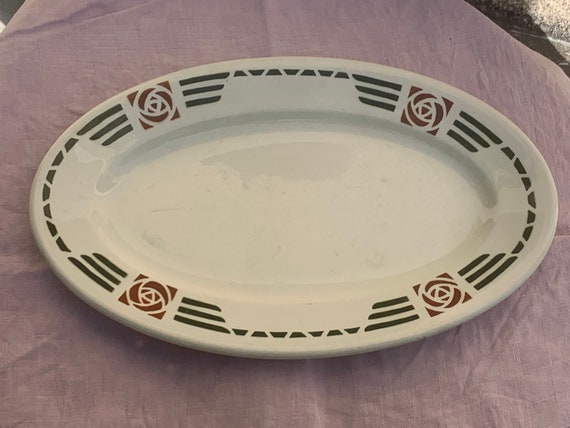 Oval serving dish, in white earthenware, art deco curved coal motifs