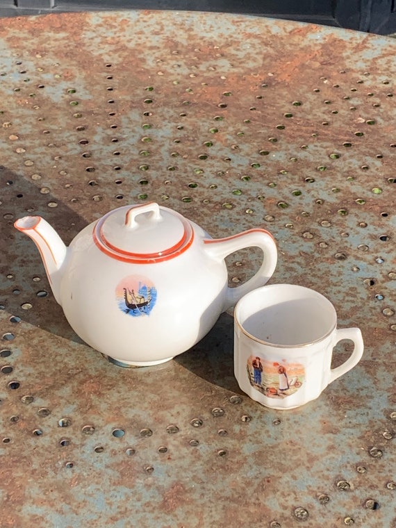 Haviland France porcelain teapot, decorated by Haviland and Cie Limoges Venice pattern and cup with reproduction of the ancient angelus.