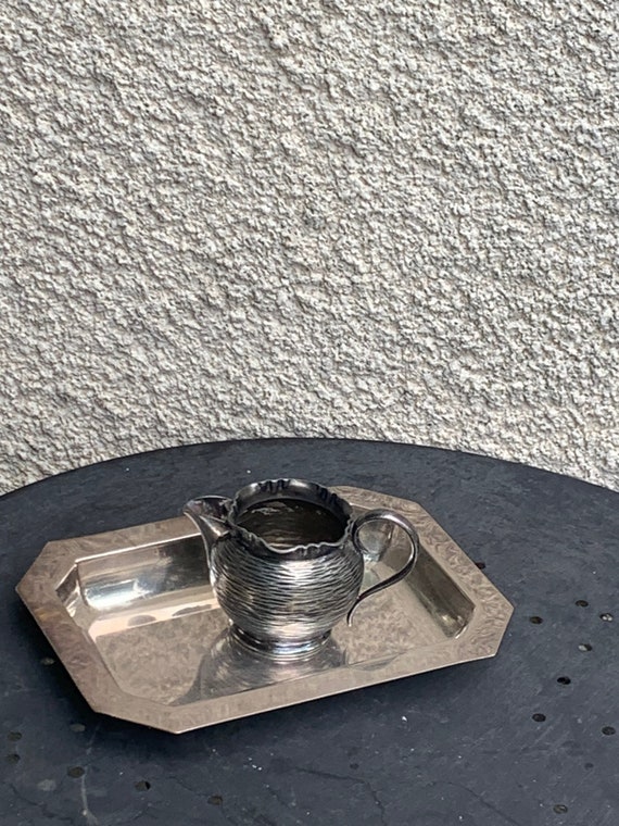 Small dish in silver metal, two punches, and a water or milk jug in vintage hammered metal