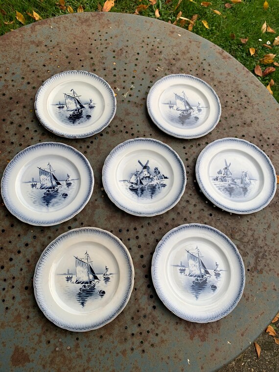 Series of 7 small dessert plates, Saint Amandinoire, Saint Amand decorated with art deco sailboats and mills, Dutch inspiration