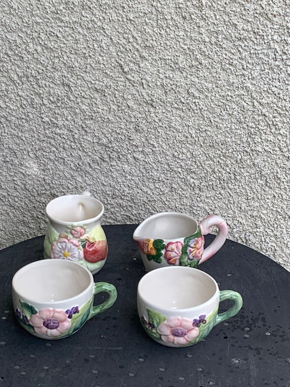 Lunch service in glazed ceramic, slip, white, pink and green, composed of two cups and two vintage milk or cream pots