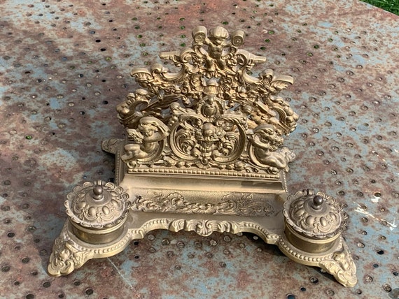 Old double inkwell in gilded brass, chiseled with old angels