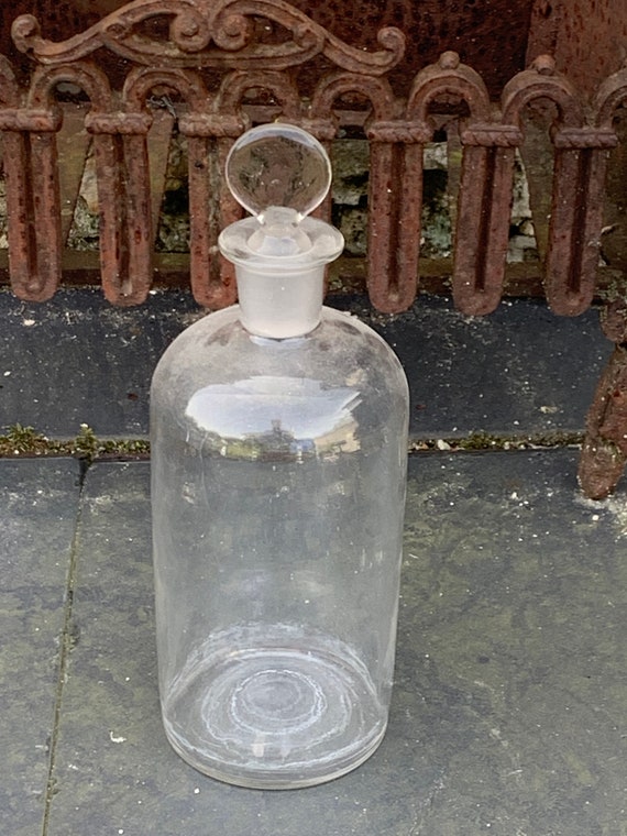 Bottle, old transparent glass bottle, transparent glass, drop-shaped cap, glass and frosted glass base