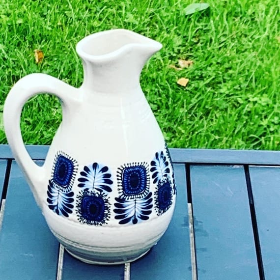 Jug, decanter, enamelled stoneware with a pretty pattern of vintage blue flowers and 1970 design.