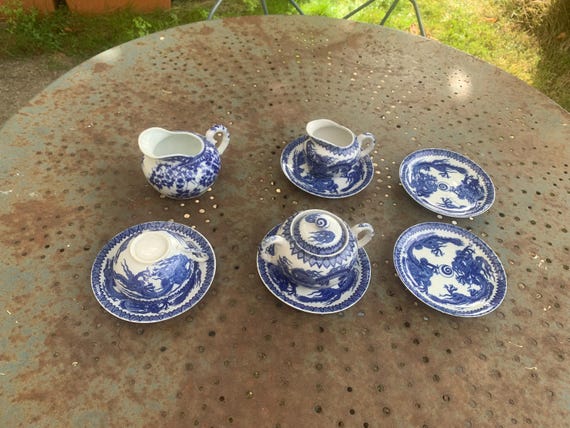 Vintage blue Japanese porcelain tea set with dragon or cherry blossom motifs