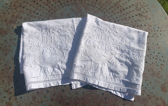 Pair of rectangular art deco pillowcases, white cotton, central floral embroidery with holes, openwork on the edges, initials EF in an angle