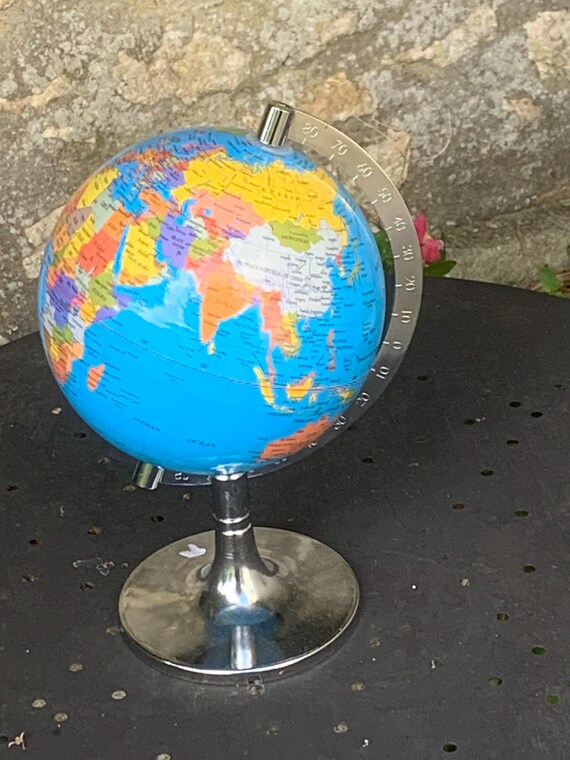 Plastic and metal rotating world map, 2018