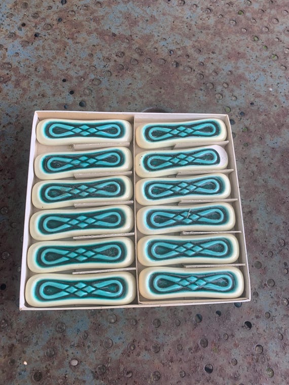 Set of 12 green and beige glazed ceramic knife holders, slip, antique, designer, and collectible.