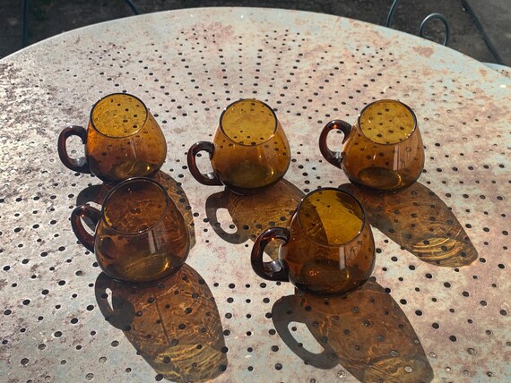 Set of 5 amber glass mugs, cups, glasses with handles, and cocktail glasses, vintage 1970s