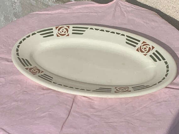 Oval serving dish, in white earthenware, art deco curved coal motifs
