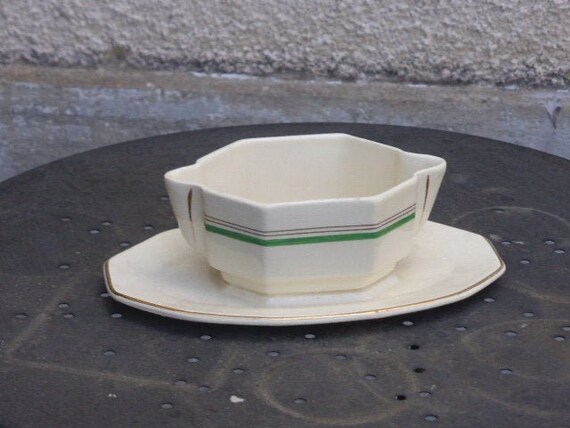 Sauceboat in white faience with a green border, St Amand made in ancient France, octagonal in shape