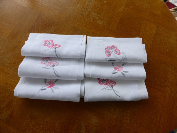 White linen napkins, embroidered with pink flowers and old monogrammed