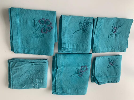 6 linen napkins, dyed emerald blue, 5 embroidered with flowers and monogrammed, GM, and one GG monogram, old