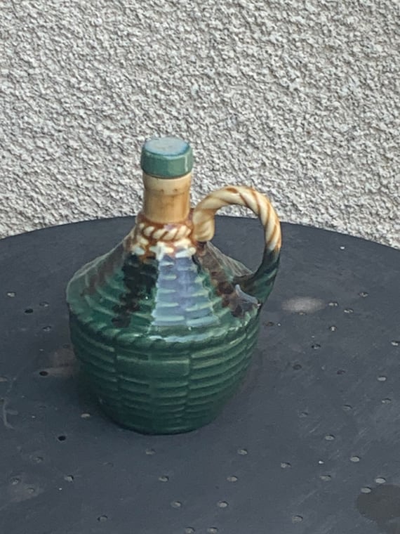 Liquor carafe, Dame Jeanne, carboy in enamelled ceramic slip in vintage green color, braiding pattern