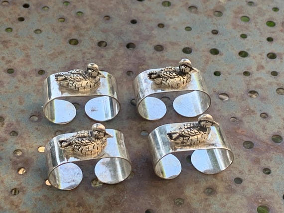 4 vintage duck napkin rings in silver-colored metal