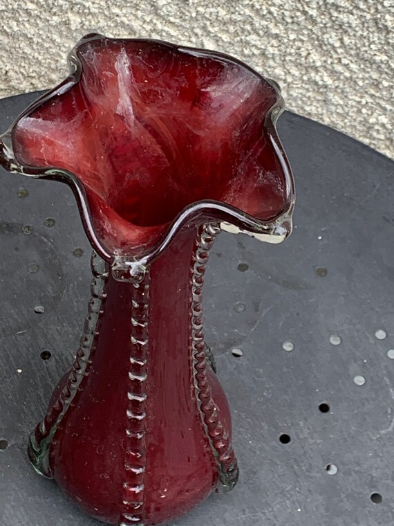 Blown glass vase in the shape of a corolla, transparent and vintage burgundy red