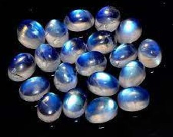 May include: A collection of 20 oval-shaped moonstone cabochons, each displaying a unique iridescent blue and white color.
