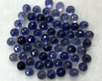 May include: A collection of 50 faceted round blue gemstone beads. The beads are approximately 6mm in diameter and have a smooth, polished finish.