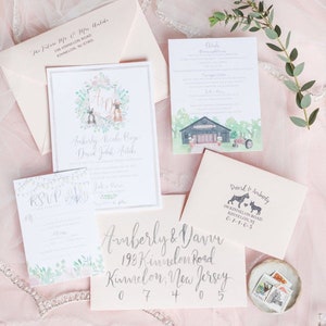 May include: Wedding invitation suite featuring a watercolour design with a barn, a tractor, and a couple of dogs. The invitation includes the couple's names, wedding date, and RSVP information. The envelope is addressed to David and Amberly, with their address and a return address stamp.