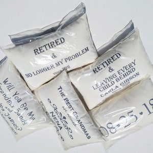 May include: Five white pillowcases with black text. The pillowcases are packaged in clear plastic bags. The text on the pillowcases reads: "Retired & No Longer My Problem since 2018", "The Best Grandmas are named Nena", "Retired & Leaving Every Child Behind Carla Gibson since 2018", "Will You Be My Grandma and Sandy? Grandpa James?", and "08-25-18".