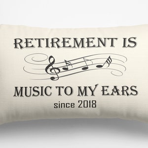 May include: A white throw pillow with the text "Retirement is music to my ears since 2018" and a musical note design.