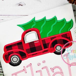 May include: Red and black plaid pickup truck with a green Christmas tree in the bed. The truck is on a white background with the name "Elijah" written in pink below it.