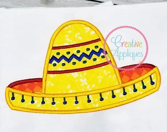 May include: A yellow felt sombrero with red, blue, and green trim. The hat has a zig-zag pattern and a small flower design.