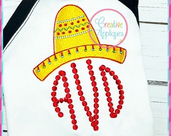 May include: Embroidered design of a red and yellow sombrero with a red beaded letter "A" on a white t-shirt. The design is for a personalized baby or toddler shirt.