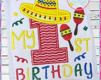 May include: Embroidered design featuring a red and white striped number one, a yellow sombrero, and maracas. The text "My 1st Birthday" is embroidered in colorful letters.