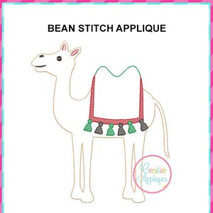 May include: A white camel applique with a red and green saddle and tassels. The applique is outlined in gold thread and is perfect for adding a festive touch to your projects.