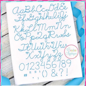 May include: A set of cursive alphabet letters and numbers in blue thread embroidery on a white fabric background. The letters are in a script font and include punctuation marks. The text below the letters reads "12 sizes: 0.3"/0.5"/0.75"/1"/1.25"/1.5"/ 1.75"/2"/2.25"/2.5"/2.75"/3"