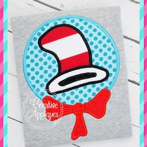May include: Red and white striped hat with a black brim and a red bow tie. The hat is on a blue background with white polka dots. The image is a digital embroidery design.
