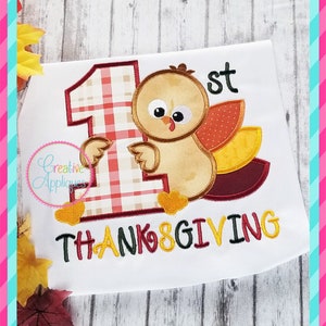 May include: Embroidered design featuring a plaid number one, a cartoon turkey, and the text "1st Thanksgiving".