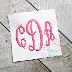 May include: A pink embroidered monogram of the letters "C D B" in a cursive script font.