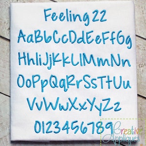 May include: A blue embroidered font set with the text "Feeling 22" and the alphabet in lowercase letters and numbers 0-9.