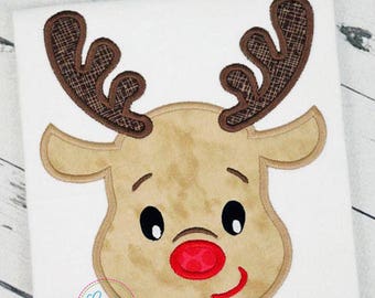 May include: Embroidered applique of a brown reindeer face with a red nose and big eyes. The reindeer has brown antlers with a plaid pattern.