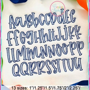 May include: A set of 13 sizes of a handwritten alphabet in blue with a white outline. The sizes range from 1 inch to 4 inches. The text "Creative Applique" is in the upper right corner of the image.
