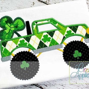 May include: Green monster truck with a shamrock on the back. The truck has a green, white, and yellow plaid pattern. The truck has black tires with shamrocks on them.